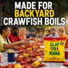 Slap Ya Mama Cajun Seafood Boil 4lb, package of Cajun seafood boil seasoning in front of a backyard lobster boil with people enjoying seafood feast.