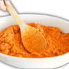 Carnival Sweet Potato Praline Casserole 2lb, close-up of a creamy sweet potato casserole with a caramelized topping in a white bowl, with a wooden serving spoon.