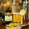 Pheris & James Margarita Cocktail Mix - 8 fl oz, bottle of non-alcoholic cocktail mix with a glass of margarita garnished with a lime slice.