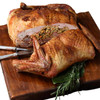 Creole Foods of Louisiana Turducken 15lbs, cooked stuffed turkey with duck and chicken layers on a wooden cutting board.