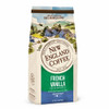 New England Coffee French Vanilla Decaf Ground 10 oz, illustrated coffee bag featuring a scenic countryside landscape with houses and rolling hills.