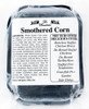 La Boucherie Smothered Corn 1lb, packaged whole kernel and creamed corn in clear plastic wrapping with a label listing ingredients and suggested recipes.
