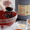 Blue Plate Concentrated Barbecue Sauce Gallon, jug of barbecue sauce being poured into a glass bowl surrounded by small bowls of spices and seasonings.