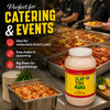 Slap Ya Mama Seafood Boil Seasoning 1 Gallon Jug, large container with a label featuring bright yellow, green, and red colors, placed on a counter with cooked seafood dishes in the background.