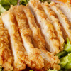 Ragin' Cajun y'ALL Purpose Breading Mix 2lb, close-up of crispy, golden-brown breaded chicken fillets with fresh salad greens in the background.