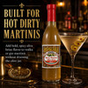 Boscoli Dirty Martini Olive Juice Hot 12.7oz, vertical bottle of spicy olive brine for martinis with a martini glass filled with olive brine and olives, bar setting background.