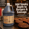 Figaro 1 Gallon Hickory Liquid Smoke and Marinade, large blue bottle of smoky liquid marinade with a barbecue grill in the background and grilled meat, sausages, and burgers on a grill, emphasizing its use for adding smoky flavor to food.