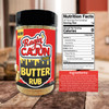Ragin' Cajun Butter Rub- 8oz, seasoning jar with black lid and bold red-and-yellow label beside nutrition facts and ingredients on a wooden countertop.