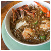 Blue Runner Seafood Gumbo Base 25oz, seafood gumbo with shrimp, crab, rice, vegetables, and spices in a bowl.