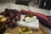 Ragin Cajun Jalapeno Relish 15oz, image of relish on a cheese and grape platter with a bowl of relish and sliced jalapenos.