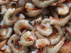 JV Foods Gulf Shrimp Headless 21/25 Ct 5lb, raw shrimp with tails, close-up view of fresh, uncooked seafood.