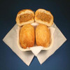 Cajun Original Crab Pistolettes 4 Pack, fried crab stuffed pastry buns with golden brown crispy exterior, two of which are cut open to reveal spicy crab filling inside.