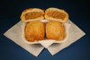 Cajun Original Alligator Pistolettes 4 Pack, golden-fried pastry stuffed with alligator meat filling, served on a white napkin.