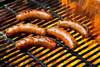 Poche's Poches Andouille 1lb, sausages grilling on a barbecue grill with flames.