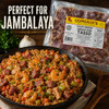 Comeaux's Pork Tasso 4lb, packaged smoked Cajun ham product with a prepared jambalaya dish featured in the foreground.