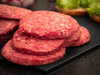 JV Foods Wagyu 5lb Ground Meat, close-up of fresh ground beef patties on a black cutting board.