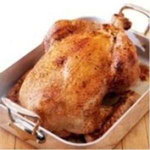 Poche's Poches Deboned Turkey with Cajun Rice, cooked whole turkey served in a baking dish with a golden-brown crispy skin.