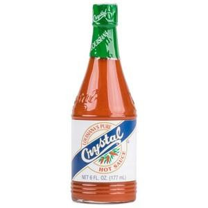 Crystal Hot Sauce 6oz, a glass bottle of spicy orange hot sauce with a green cap and label.