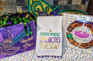 Creole Foods of Louisiana King Cake Box, colorful packaging with the king cake and Mardi Gras themed decorations.