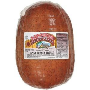 Manda Fine Meats Manda Cajun Prize Spicy Turkey, raw whole spicy turkey breast in packaging with label and nutrition information.
