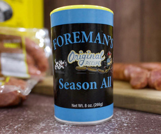 Foreman's Seasoning 8oz, spice container with a black and blue label featuring cartoon characters and text.