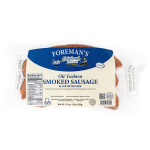 Foreman's Ole' Fashion Smoked Sausage 1lb, packaged smoked sausage with a visible charred exterior and a slightly rough surface.