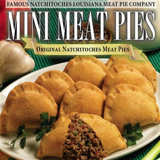 Natchitoches Meat Pies Natchitoches Mini Meat Pies 12ct, image of golden-brown mini meat pies on a white plate with some herbs and a garlic bulb in the background.