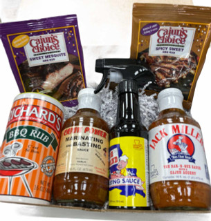 Barbeque Sampler Kit, assortment of barbecue sauces and rubs including Cajun's Choice Sweet Mesquite BBQ Rub, Spicy Sweet BBQ Rub, Richard's BBQ Rub, Cajun Power Marinating and Basting Sauce, Jack Millers BBQ Sauce, and a spray bottle along with two seasoning spice packets for grilling and barbecue.