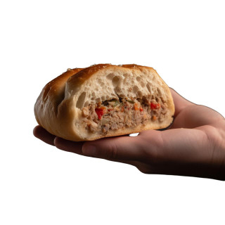 M&R Creole's Stuffed Bread 4ct, hand holding a stuffed bread with a filling of seasoned ground meat and vegetables inside a soft, golden-brown bread roll.