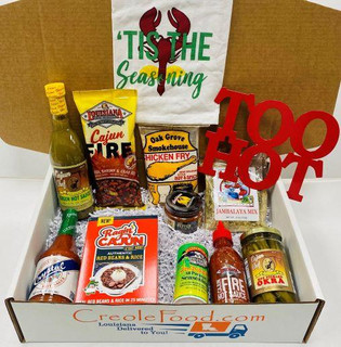 Creole Foods of Louisiana I Like it Hot Hot Hot Gift Box, a collection of spicy Cajun food products including hot sauce, seasoning, and snacks in a gift box with a shopping bag.