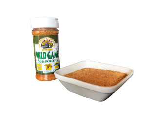 Ragin Cajun Wild Game Seasoning 6oz, spice mixture in a white dish and a container with the seasoning label showing.