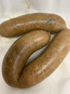 The Best Stop Mild Boudin 64oz, raw sausage encased in a natural casing, prepared for cooking or grilling.