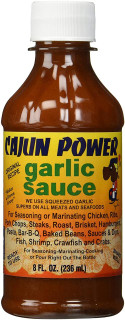 Cajun Power Garlic Sauce 8oz, image of a brown glass bottle with a white cap and a colorful label featuring the product name and description.