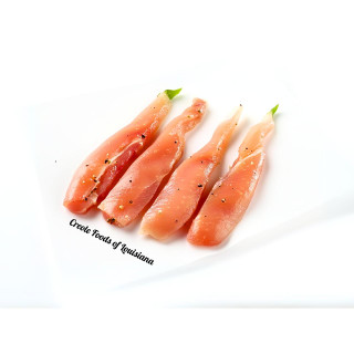 Alligator Tenderloins 2lb, fresh raw alligator tenderloins seasoned with black pepper on white background.