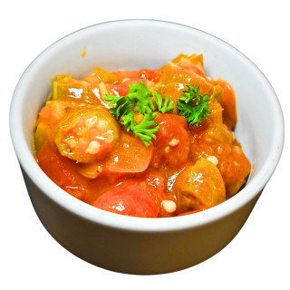 Carnival Okra and Tomatoes 4lb, fresh and vibrant sliced okra and ripe tomatoes in a white bowl garnished with parsley.