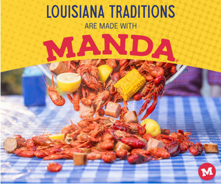 Manda Fine Meats Manda Mild Smoked Sausage 3lb Loops, a heap of cooked smoked sausage loops with lemon, corn on the cob, and cookies on a blue checkered table.