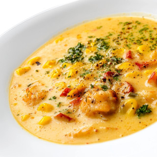 Carnival Crawfish, Corn, and Crab Soup 4lb, bowl of creamy seafood soup with crawfish, corn, and herbs.