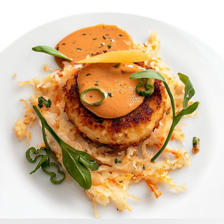Carnival 48% Crab Cakes 3oz 6 Pack, Gourmet crab cakes with sauce and garnishes on a white plate