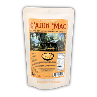 Dip Me Cajun Style Mac and Cheese 5.5oz, packaging featuring an illustration of a Cajun-style hut in a forest setting, with recipe instructions and nutrition facts printed on the label.