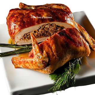 Creole Foods of Louisiana Turducken 15lbs, whole stuffed poultry dish with sliced portion on white plate garnished with herbs.