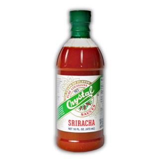 Crystal Sriracha Sauce 16oz, a translucent plastic bottle filled with bright red sriracha hot sauce, with a green cap and a white label featuring green, red, and gold accents.