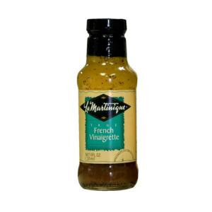 La Martinique True French Vinaigrette 10 oz, bottled salad dressing with mustard seeds and herbs visible inside the transparent glass bottle.