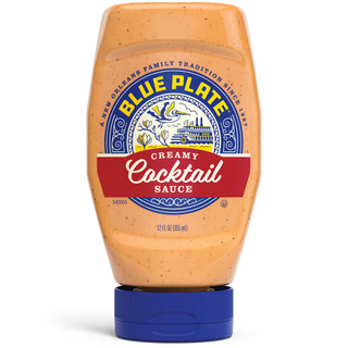 Blue Plate Creamy Cocktail Sauce 12 oz, a squeeze bottle of creamy orange cocktail sauce with specks of spices, featuring a blue cap and a detailed label with a boat, a bird, and the brand's logo.