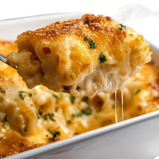 Carnival Macaroni & Cheese 4lb, close-up of baked cheesy macaroni and cheese being served on a spoon with melted cheese and crispy topping.