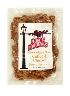 Creole Delicacies Coffee & Chicory Pecanfections, a clear plastic bag filled with pecan-flavored coffee and chicory treats with a label featuring a black street lamp and red ribbon.
