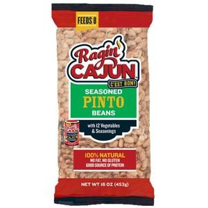 Ragin Cajun Seasoned Pinto Beans, vibrant 16oz package with images of seasoned pinto beans and vegetables on the label.