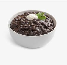 Dr Gumbo Black Bean Soup 2.5lb, a bowl of rich and hearty black bean soup garnished with a dollop of sour cream and fresh cilantro on top.