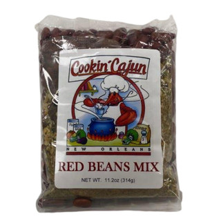 Cookin' Cajun Red Beans Mix, packaged in a clear plastic bag with a label showing a cartoon shrimp chef stirring a pot, featuring red beans and various seasonings in the background.
