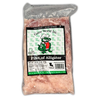 Gator World Alligator Filets 1lb, frozen alligator meat in clear vacuum-sealed packaging with a label featuring a cartoon alligator chef, nutritional info, and USDA certification.
