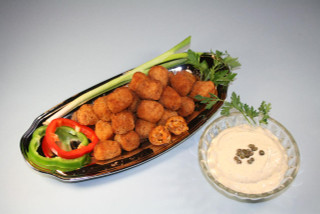 Cajun Original Alligator Bites 12lb, crispy fried alligator bites served with fresh vegetables and dipping sauce.